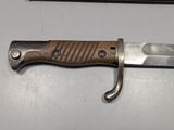 a knife that is sitting on a table next to a pen