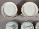 three cups and saucers sitting on top of a white table