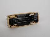 a black and gold electronic device sitting on a white surface