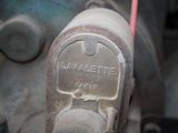 a close up of a metal object with a red handle