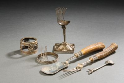 a silverware set with spoons, forks, and spoon rest