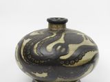 a black and white vase with an octopus design on it