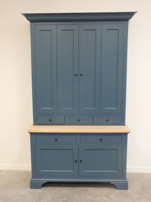 une grande armoire bleue avec deux tiroirs et un plateau en bois