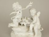 a white statue of two cherensils on a table