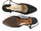 two pairs of black sued shoes with gold accents on the toes