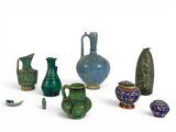 many different types of vases and bowls on the table