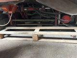underside of a truck with a pallet underneath it on the ground
