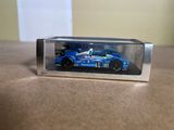 a blue toy car in a clear box on a table