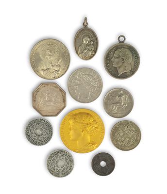 an assortment of coins and pendants on a white surface