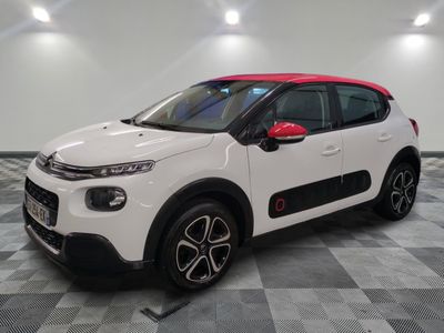 a white and red citrole car parked in a garage