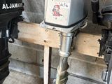 deux moteurs hors-bord posés sur un support en bois dans un garage