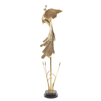 une statue en or représentant un oiseau posé sur une plante