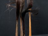 two wooden hair brushes sitting next to each other on a table