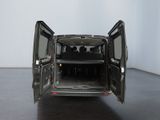 a black van with its doors open in a room