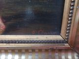 an oil painting of a woman ' s feet in a gold frame