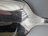 a silver spoon that is sitting on a table