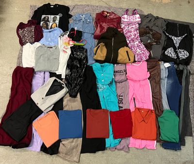 a pile of clothes that is laying on the floor