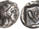a silver coin with an image of a woman on it