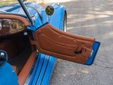 a close up of a blue car with its door open