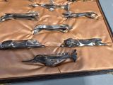 a lot of metal dogs in a case on a table