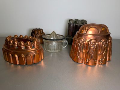 many different types of cake pans sitting on a table