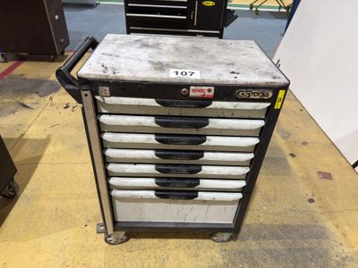 a metal tool cart with five drawers on it