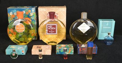 many different types of perfumes and boxes on the table