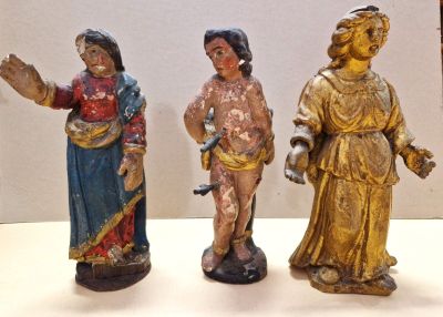 three figurines that are standing on a table