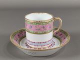 a close up of a cup and saucer on a table