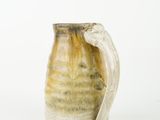 a brown and white vase with a handle on a white background