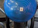 a blue frisbee sitting on a tread in a gym