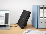 a laptop computer sitting on a desk next to a monitor