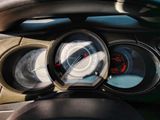 a close up of a car dashboard with various gauges
