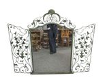 a man standing in front of a mirror in a room