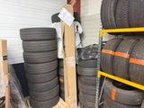 many tires stacked on a pallet in a warehouse