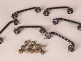 a bunch of metal handles and screws on a white surface
