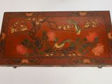 a red box with birds and flowers on it