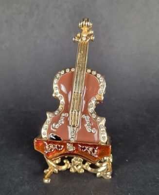 an image of a miniature violin sitting on top of a table