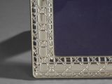 an antique silver picture frame with a blue glass in the middle