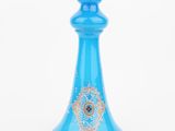 an image of a blue glass perfume bottle on a white background