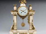 une image représentant une horloge blanche et dorée posée sur une table