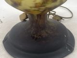 a glass lamp that is sitting on top of a table