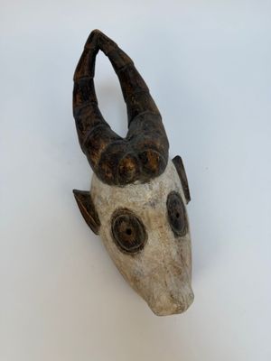 une image représentant une sculpture représentant une tête de chèvre sur une surface blanche