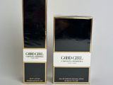 a couple of boxes of perfume sitting on top of a white surface