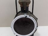 a black and white lantern sitting on a white table