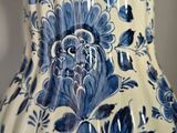 a blue and white vase with blue flowers on it