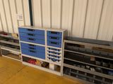 a storage area with many drawers and shelves in it