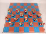 chess board with red and blue squares and red flowers on it
