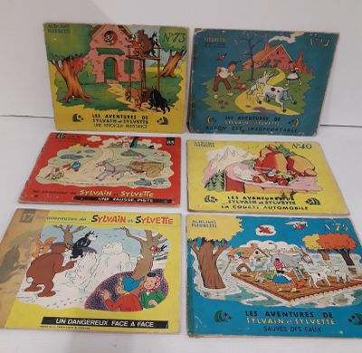 quatre livres pour enfants sont alignés sur une surface blanche