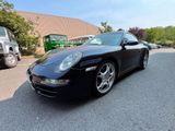 a picture of a black porsche parked in a parking lot